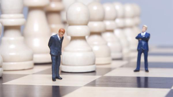 1:150 scale figures of two layers on a full-sized chessboard